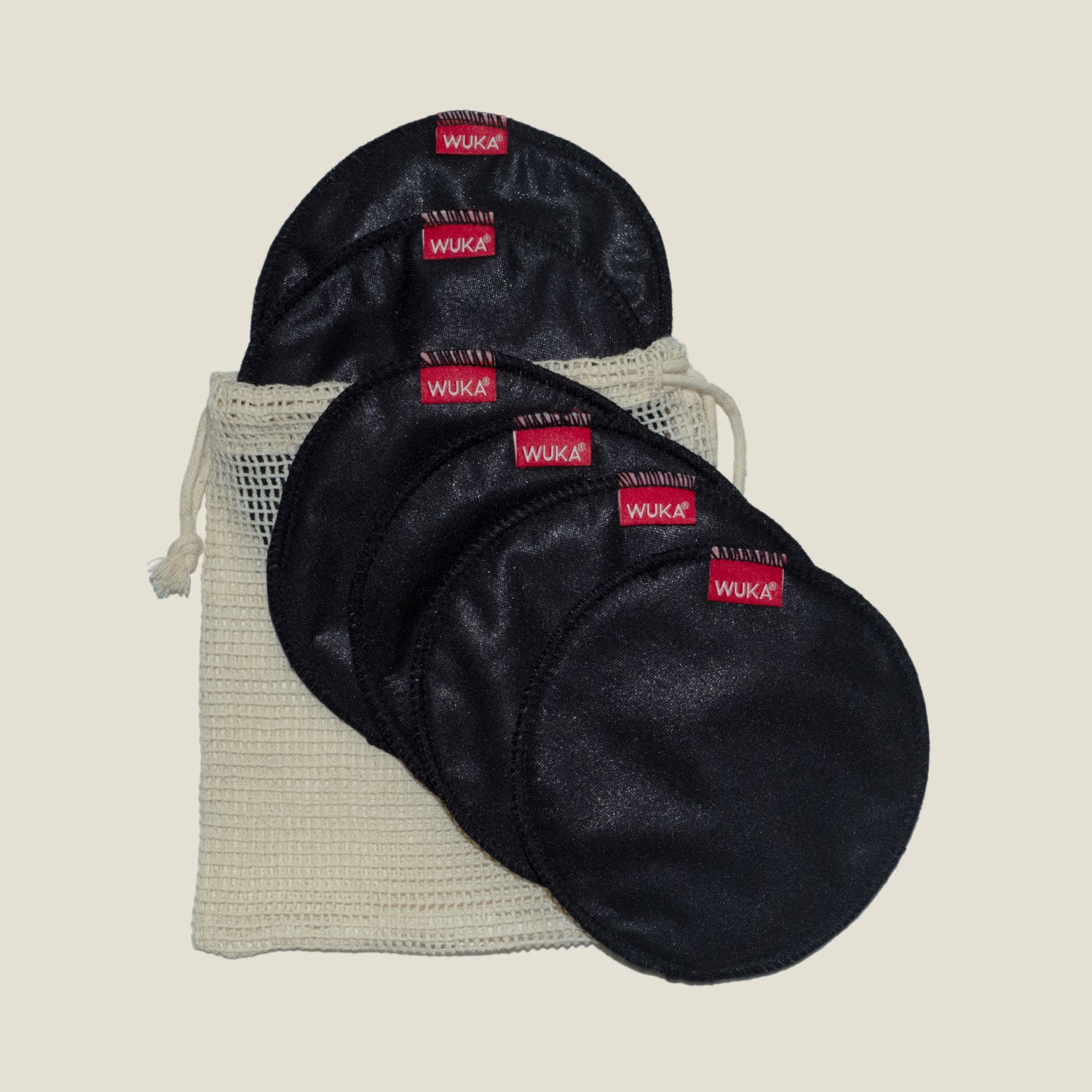 Set of six WUKA Maternity Nursing Pads displayed with a breathable cotton mesh wash bag, ideal for eco-friendly breastfeeding support.