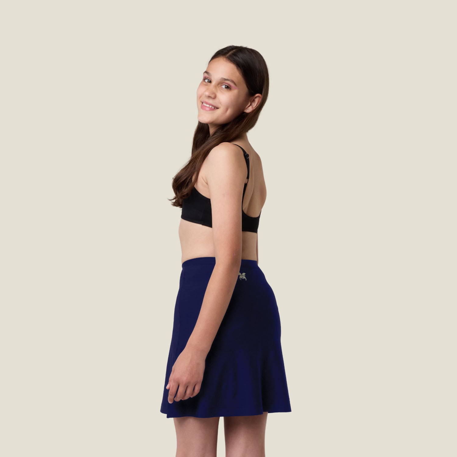 Detailed view of WUKA Teen Skort in navy — stretchy, breathable fabric with built-in period pants.