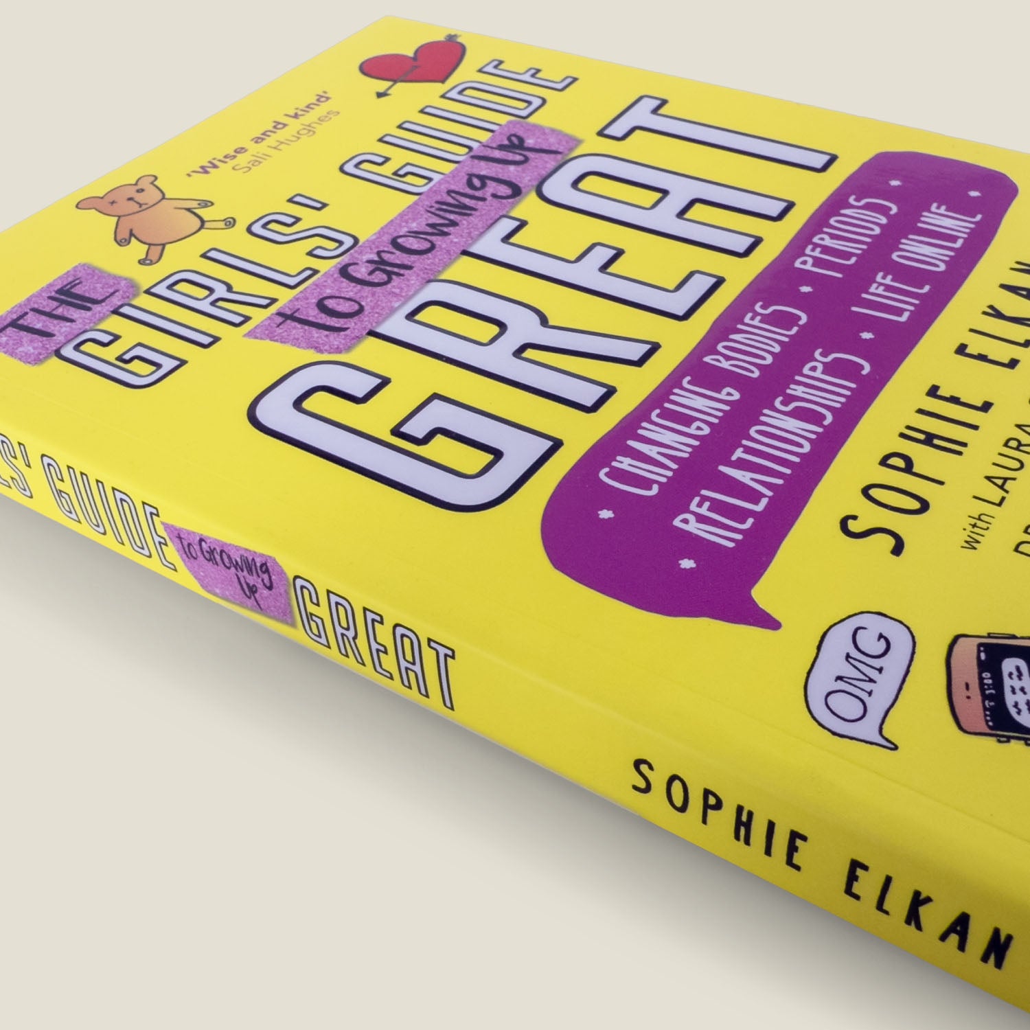 Angled shot of The Girls' Guide to Growing Up Great by Sophie Elkan, showcasing its bold yellow cover and playful illustrations for teen readers.