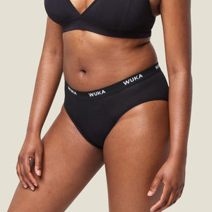 Side profile of WUKA Midi Brief period underwear showing smooth waistband and mid-rise design for postpartum support and leak protection.