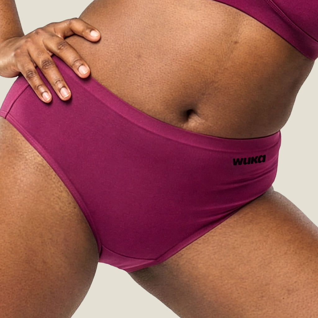 Close-up lifestyle image of WUKA Stretch™ Midi Brief in Burgundy for heavy flow, showcasing a comfortable fit with soft stretch fabric for period protection. Sustainable and reusable period underwear for maximum comfort and leak-proof confidence.